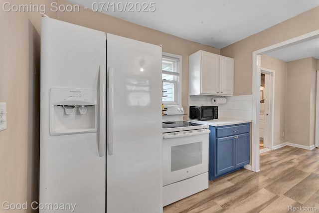 36149 Schley Ave, Van Buren, MI 48186 - kitchen featuring white appliances, blue cabinets, light countertops, light wood-type flooring, and tasteful backsplash
