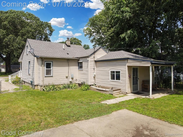 36149 Schley Ave, Van Buren, MI 48186 - back of house with a chimney, roof with shingles, and a patio