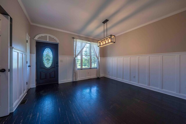 4433 Elm St, New Era, MI 49446 - foyer with a decorative wall, a wainscoted wall, wood finished floors, and ornamental molding