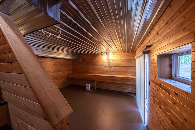 4433 Elm St, New Era, MI 49446 - relaxing sauna / steam room featuring concrete flooring, wooden walls, and wooden ceiling