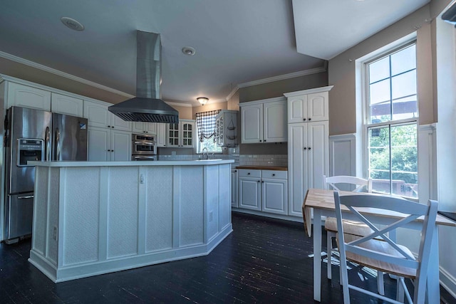 4433 Elm St, New Era, MI 49446 - kitchen with appliances with stainless steel finishes, island exhaust hood, white cabinets, ornamental molding, and glass insert cabinets