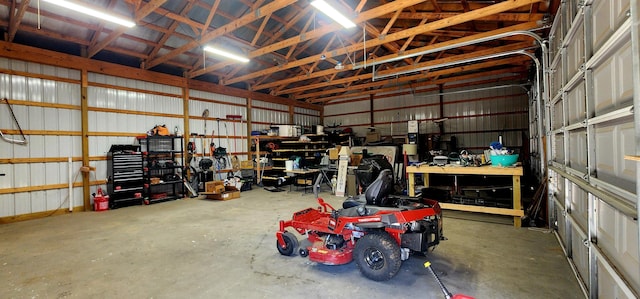 4433 Elm St, New Era, MI 49446 - garage with a workshop area and metal wall