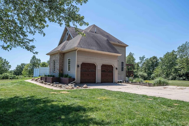 4433 Elm St, New Era, MI 49446 - view of property exterior featuring a garage, a yard, concrete driveway, and roof with shingles