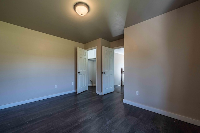4433 Elm St, New Era, MI 49446 - unfurnished bedroom with dark wood-style floors and baseboards