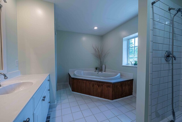 4433 Elm St, New Era, MI 49446 - bathroom with a stall shower, tile patterned flooring, vanity, a garden tub, and recessed lighting