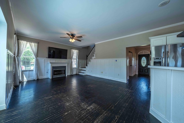4433 Elm St, New Era, MI 49446 - unfurnished living room with ceiling fan, a fireplace, dark wood finished floors, crown molding, and stairway