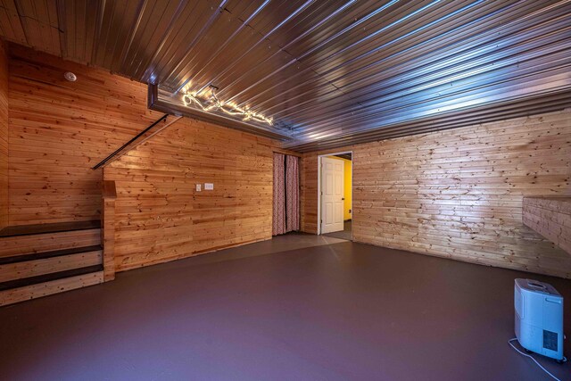 4433 Elm St, New Era, MI 49446 - unfurnished room with finished concrete flooring and wooden walls