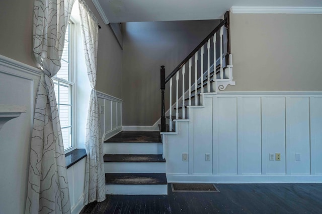 4433 Elm St, New Era, MI 49446 - stairway with wood finished floors, a wainscoted wall, a decorative wall, and ornamental molding