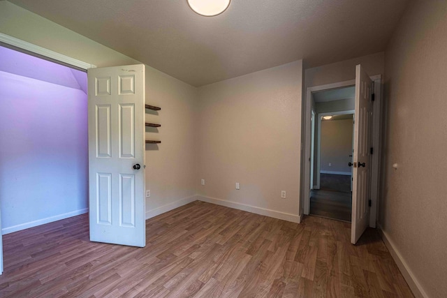 4433 Elm St, New Era, MI 49446 - unfurnished bedroom with wood finished floors