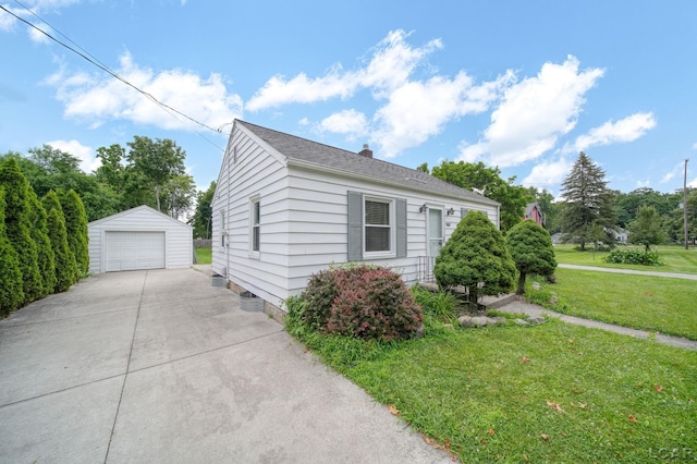 309 E Logan St, Tecumseh, MI 49286 - view of home's exterior with an outdoor structure, a garage, a yard, concrete driveway, and a chimney