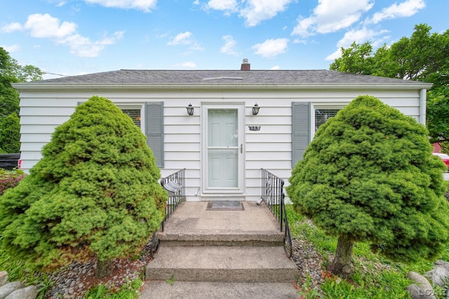 309 E Logan St, Tecumseh, MI 49286 - property entrance with a chimney