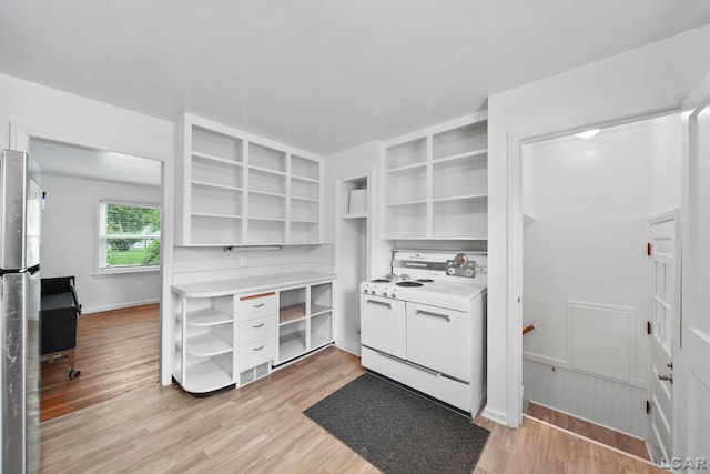 309 E Logan St, Tecumseh, MI 49286 - kitchen with open shelves, white electric range, light wood-style floors, and light countertops