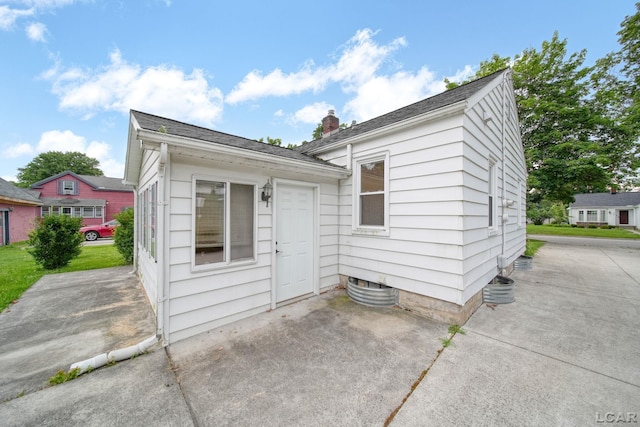 309 E Logan St, Tecumseh, MI 49286 - view of front facade featuring a patio and a chimney
