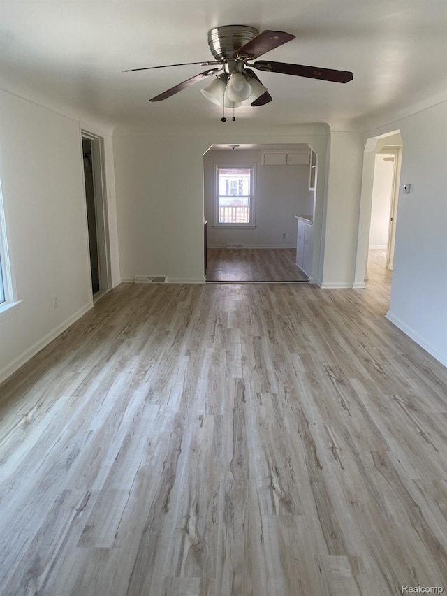 3512 Barry St, Wayne, MI 48184 - unfurnished living room with a ceiling fan, arched walkways, and light wood-style floors