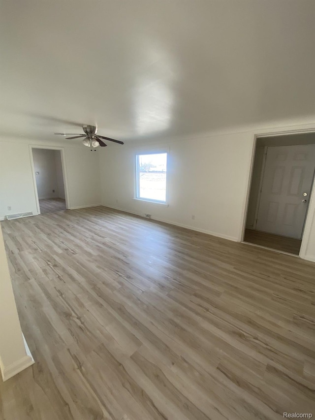 3512 Barry St, Wayne, MI 48184 - unfurnished living room with a ceiling fan and light wood-style floors