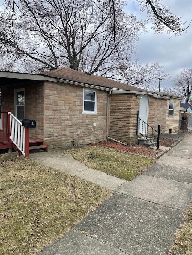 3512 Barry St, Wayne, MI 48184 - view of front of home with stone siding, a shingled roof, and a front yard