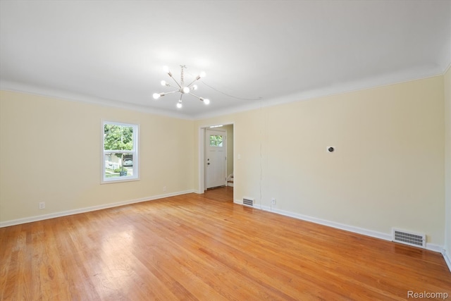 1516 Gainey Ave, Flint, MI 48503 - empty room with crown molding, a chandelier, and light wood-style flooring