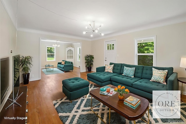 1516 Gainey Ave, Flint, MI 48503 - living room featuring a chandelier, wood finished floors, and ornamental molding