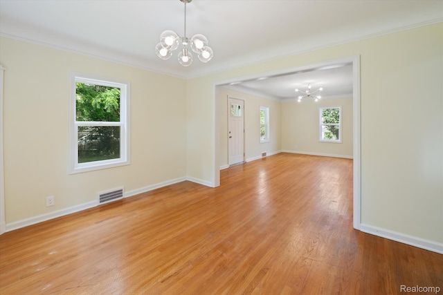 1516 Gainey Ave, Flint, MI 48503 - unfurnished room with a chandelier, crown molding, and light wood finished floors