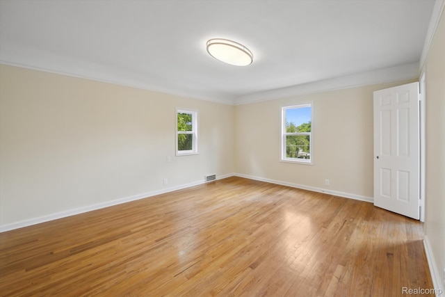 1516 Gainey Ave, Flint, MI 48503 - spare room featuring healthy amount of natural light, light wood-style floors, and crown molding