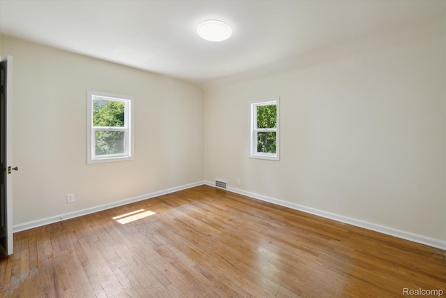 1516 Gainey Ave, Flint, MI 48503 - empty room with plenty of natural light and hardwood / wood-style flooring