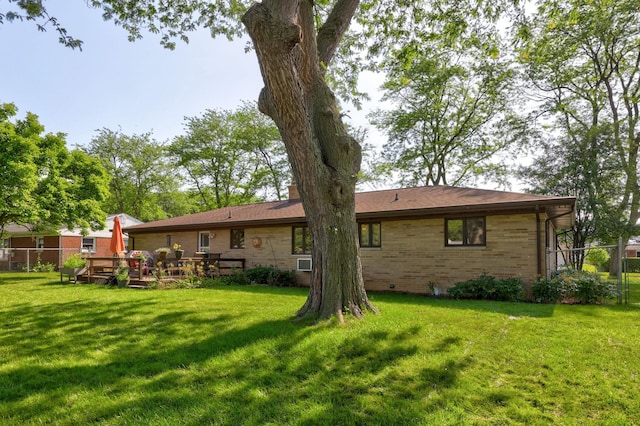 120 Sunburst Dr, Frankenmuth, MI 48734 - rear view of house with brick siding, a chimney, and a wooden deck