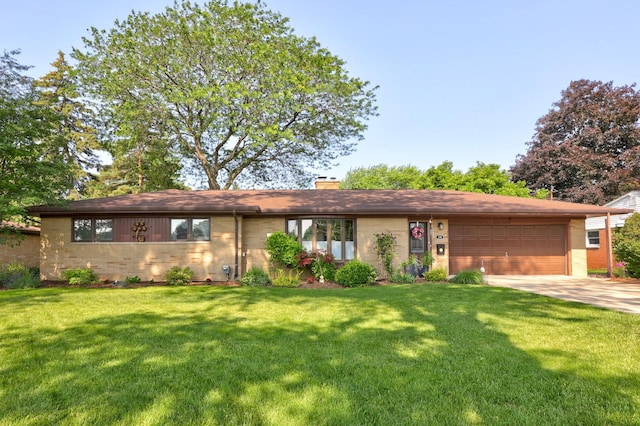 120 Sunburst Dr, Frankenmuth, MI 48734 - view of front of house featuring an attached garage, concrete driveway, a chimney, brick siding, and a front lawn