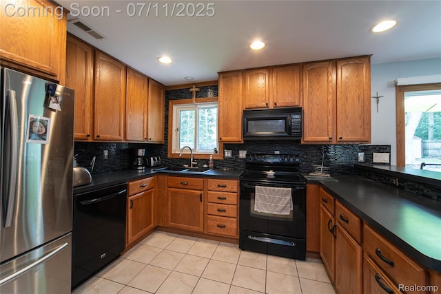 3238 Homestead Dr, Waterford, MI 48329 - kitchen featuring black appliances, healthy amount of natural light, dark countertops, tasteful backsplash, and recessed lighting