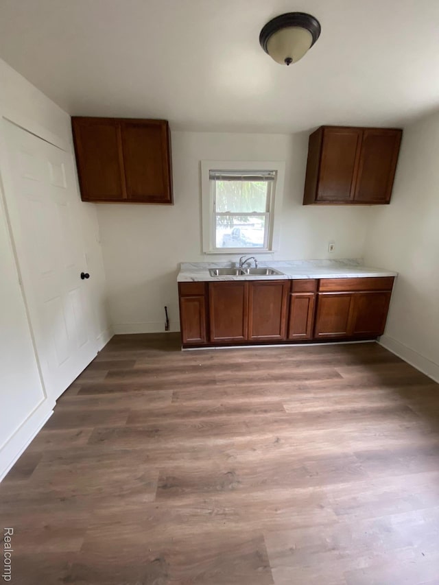 15354 Oldham St, Taylor, MI 48180 - kitchen with brown cabinets, light wood-style flooring, and light countertops
