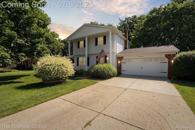 2210 Old Hickory Blvd, Davison, MI 48423 - view of front of house featuring a front lawn, driveway, a garage, and brick siding