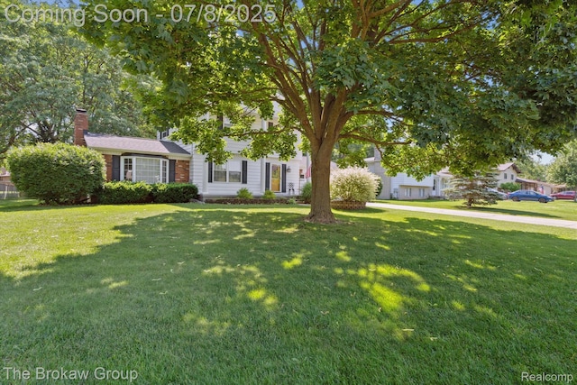2210 Old Hickory Blvd, Davison, MI 48423 - view of property hidden behind natural elements with a chimney and a front lawn