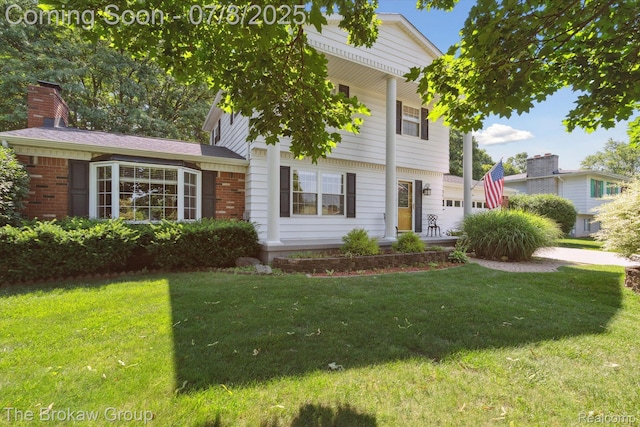 2210 Old Hickory Blvd, Davison, MI 48423 - view of front of house featuring a front lawn, a chimney, and brick siding