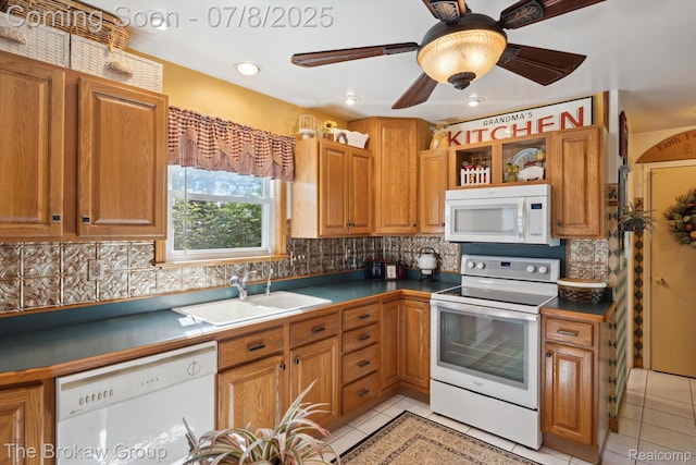 2210 Old Hickory Blvd, Davison, MI 48423 - kitchen featuring white appliances, light tile patterned flooring, decorative backsplash, and brown cabinetry