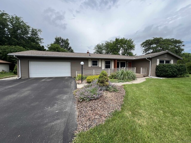 2244 Shannon Dr, Adrian, MI 49221 - single story home featuring driveway, a porch, an attached garage, and a front lawn