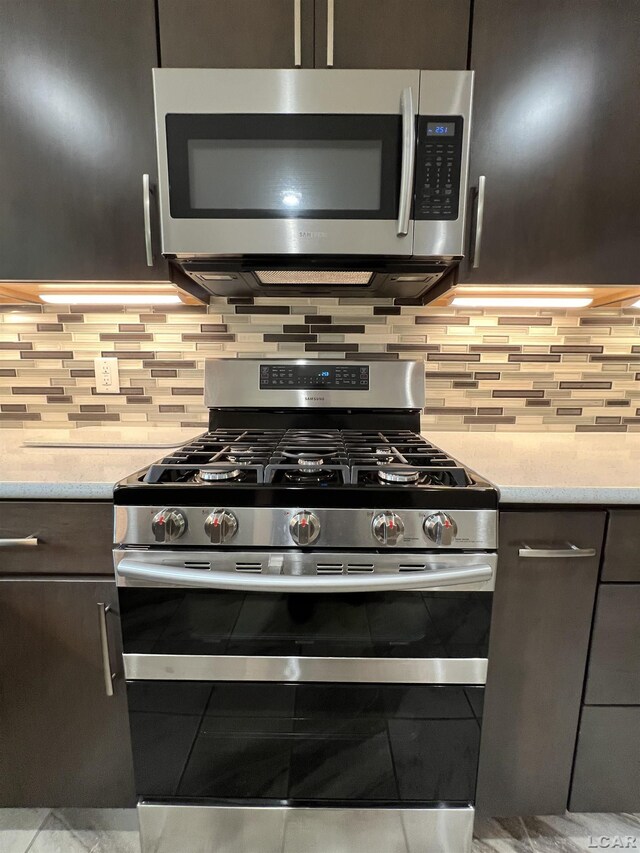 2244 Shannon Dr, Adrian, MI 49221 - kitchen featuring stainless steel appliances, backsplash, and light stone countertops
