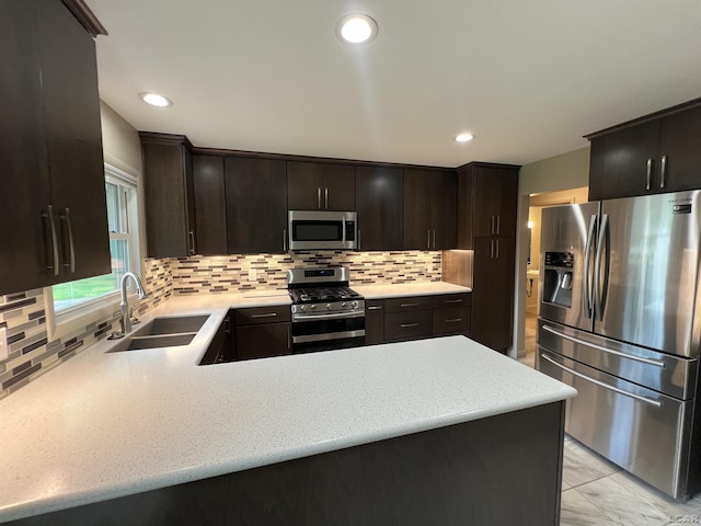 2244 Shannon Dr, Adrian, MI 49221 - kitchen with appliances with stainless steel finishes, tasteful backsplash, a peninsula, recessed lighting, and light marble finish flooring