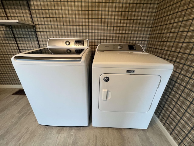 2244 Shannon Dr, Adrian, MI 49221 - laundry room with wood finished floors, washer and dryer, and wallpapered walls