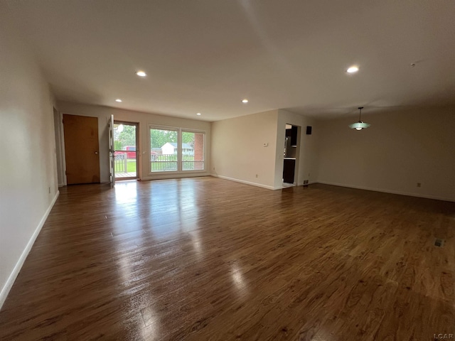2244 Shannon Dr, Adrian, MI 49221 - unfurnished living room featuring dark wood-style floors and recessed lighting