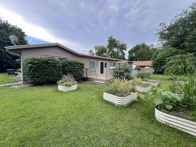 2244 Shannon Dr, Adrian, MI 49221 - rear view of property with a yard and a deck