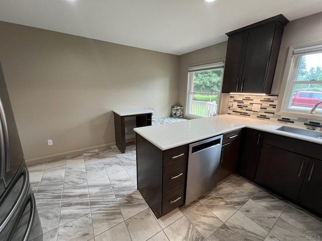 2244 Shannon Dr, Adrian, MI 49221 - kitchen with dishwasher, a peninsula, plenty of natural light, and light countertops