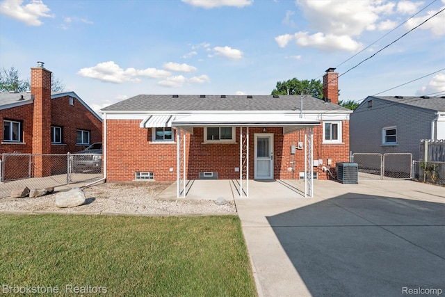 15101 Drake St, Southgate, MI 48195 - rear view of house featuring brick siding, a gate, and a shingled roof