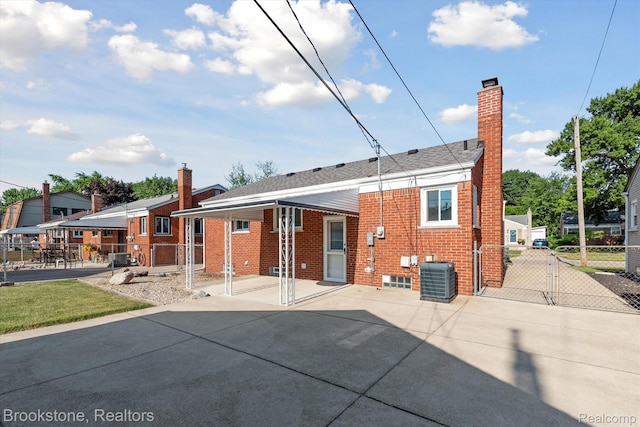 15101 Drake St, Southgate, MI 48195 - back of property featuring a chimney, brick siding, a gate, and a patio