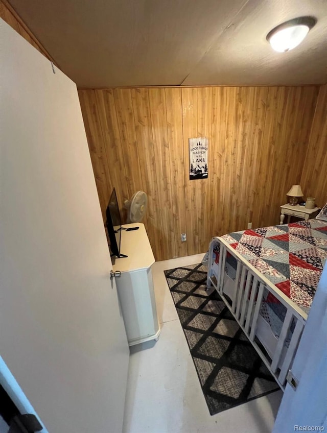 5315 E 8th St, Au Gres, MI 48703 - bedroom featuring wooden walls and finished concrete flooring