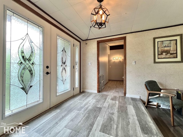 4949 S Iva Rd, Merrill, MI 48637 - foyer entrance with wood finished floors, a chandelier, and crown molding