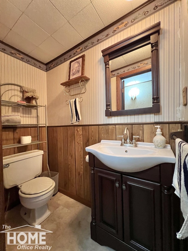 4949 S Iva Rd, Merrill, MI 48637 - bathroom with vanity, wainscoting, and wooden walls
