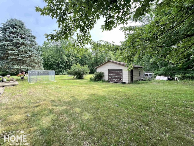 4949 S Iva Rd, Merrill, MI 48637 - view of grassy yard with a detached garage and an outdoor structure