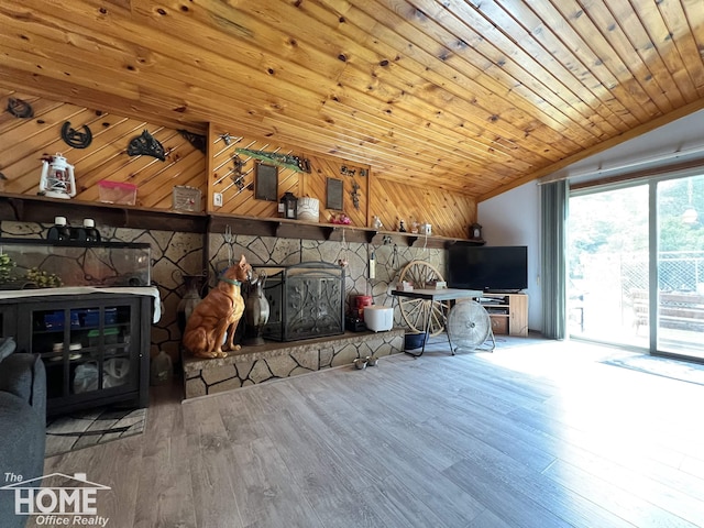 4949 S Iva Rd, Merrill, MI 48637 - living area featuring lofted ceiling, wood finished floors, wood ceiling, wooden walls, and a fireplace