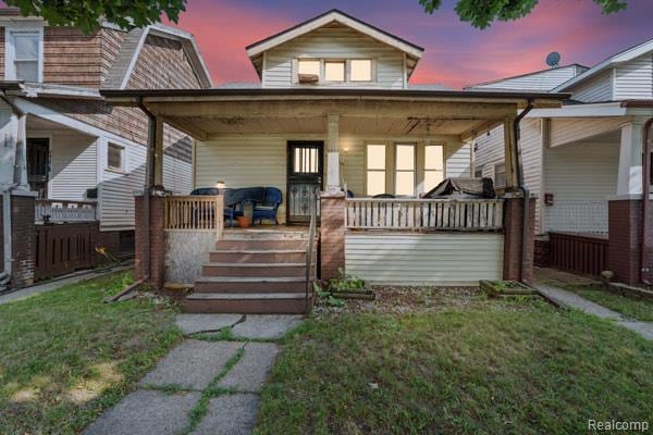 6431 Wagner, Detroit, MI 48210 - view of front of property featuring a porch and a yard