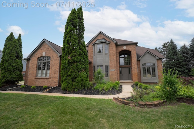 24145 Windridge Ln, Novi, MI 48374 - traditional-style home featuring brick siding and a front lawn