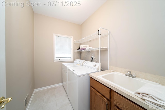 24145 Windridge Ln, Novi, MI 48374 - laundry room with washer and clothes dryer, light tile patterned floors, and cabinet space